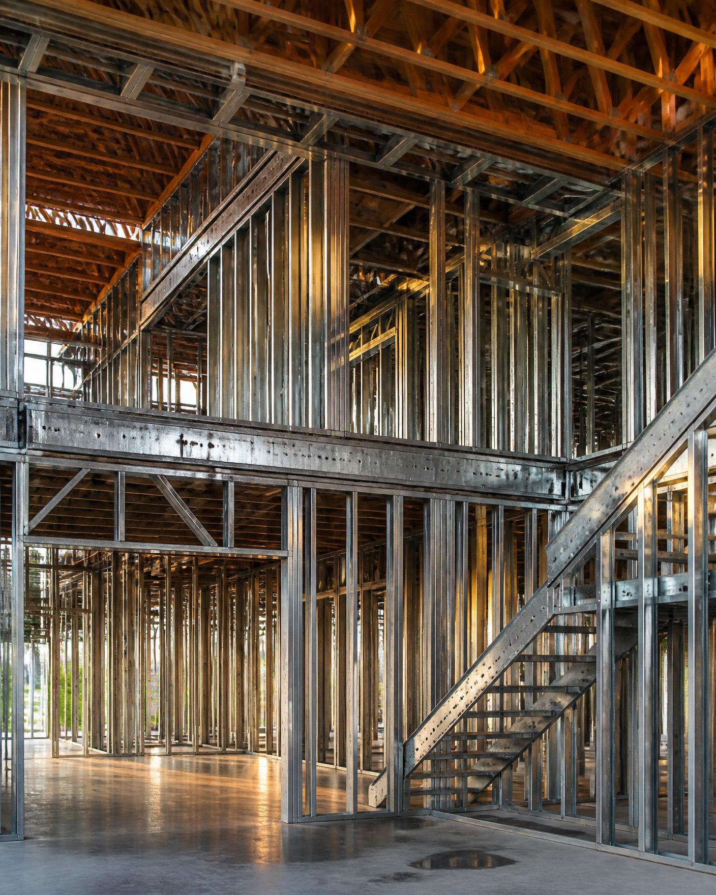 Precise light gauge steel and timber framing inside a building under construction